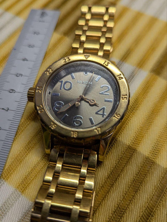 Pre-Owned Nixon The 38-20 Gold Tone Stainless Steel Watch 200M Women’s – Not Working – For Repair